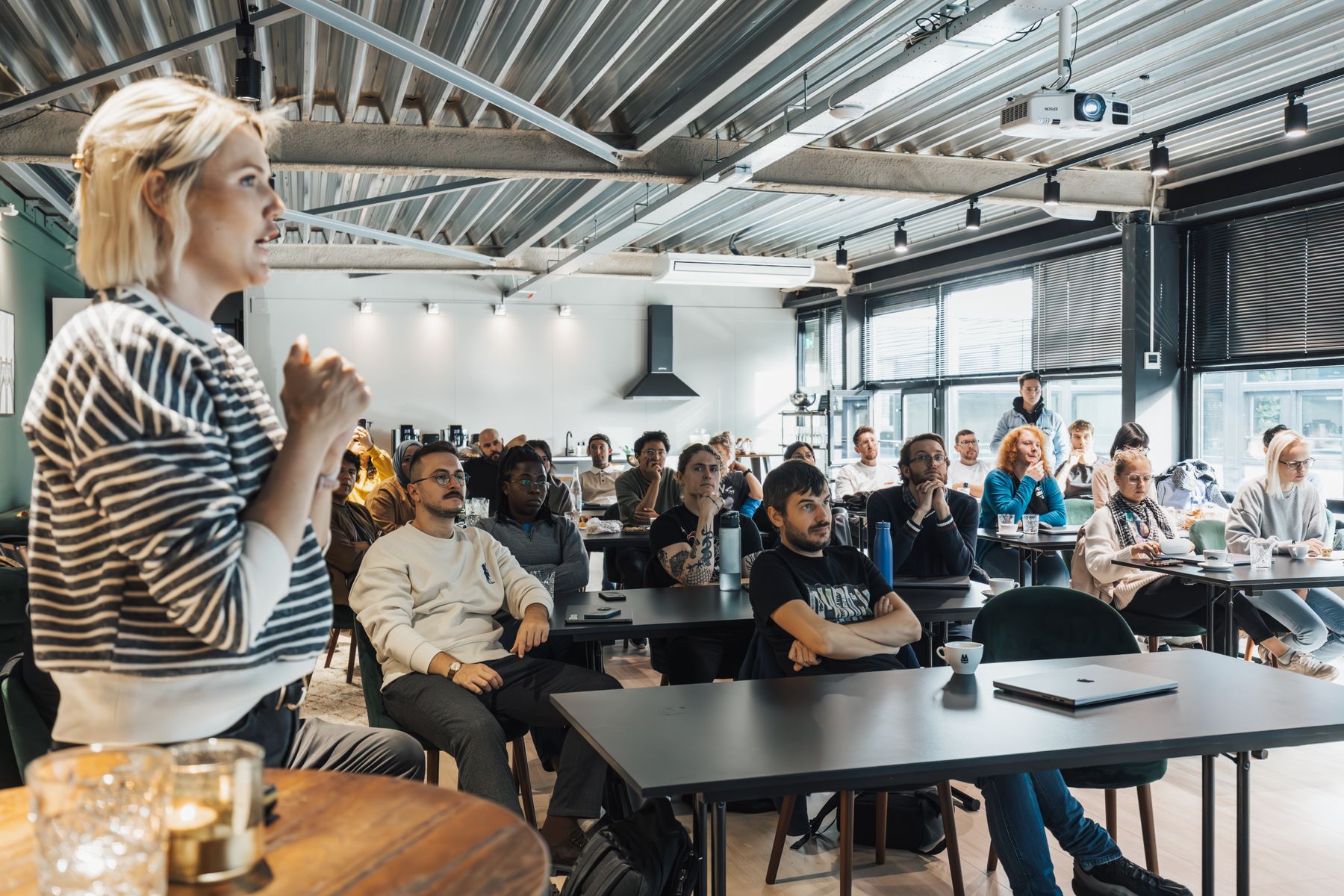 A professional coach leading an engaged workshop in a modern classroom